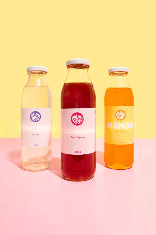 Three bottles, one fructose, one strawberry syrup, and one bottle of mango syrup